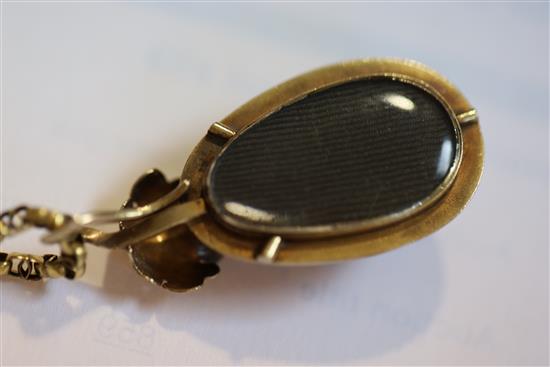 A Victorian gold mounted pear shaped cabochon garnet pendant on oval link chain, pendant 35mm.